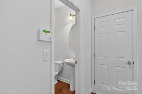 a bathroom with a granite countertop toilet and a sink