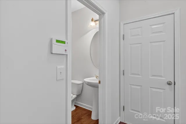 a bathroom with a granite countertop toilet and a sink