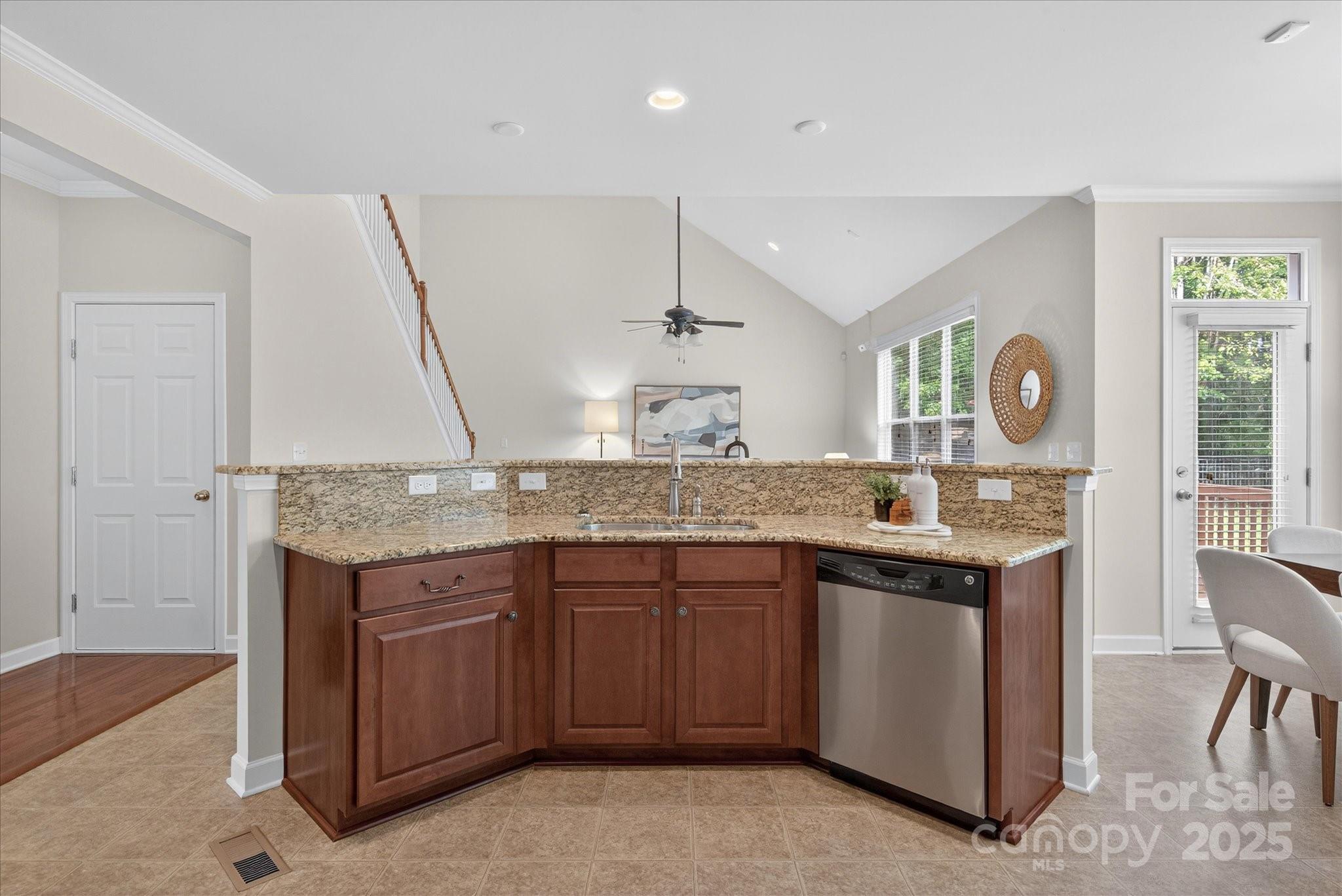 945 Vogel Way Fort Mill, SC 29715 - Photo 17 of 47 a kitchen with granite countertop a sink and a stove