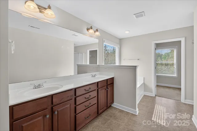 a bathroom with a sink double vanity and a mirror