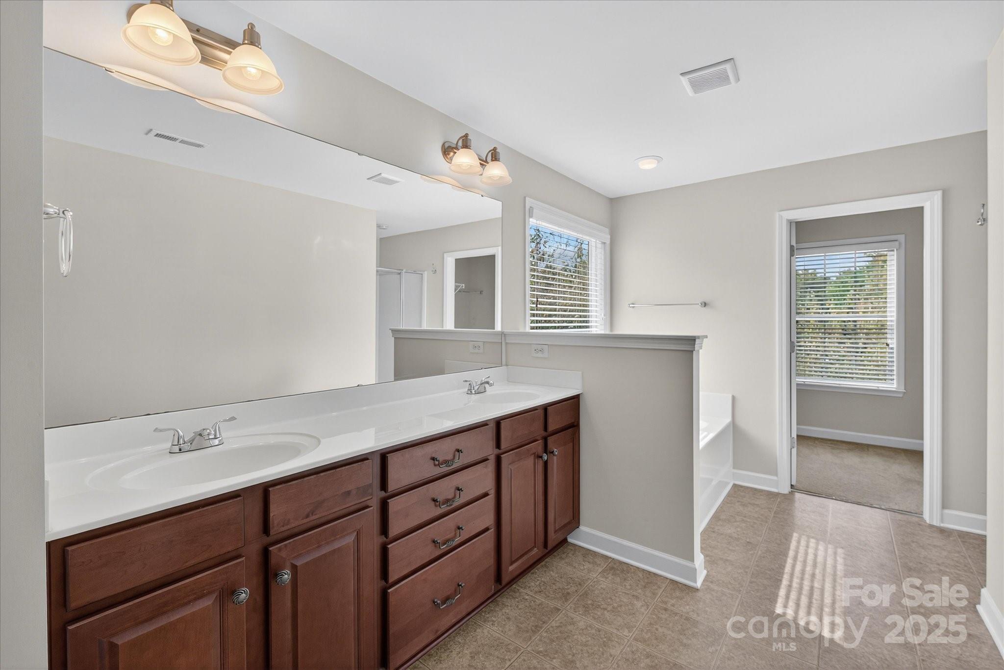 945 Vogel Way Fort Mill, SC 29715 - Photo 28 of 47 a bathroom with a sink double vanity and a mirror