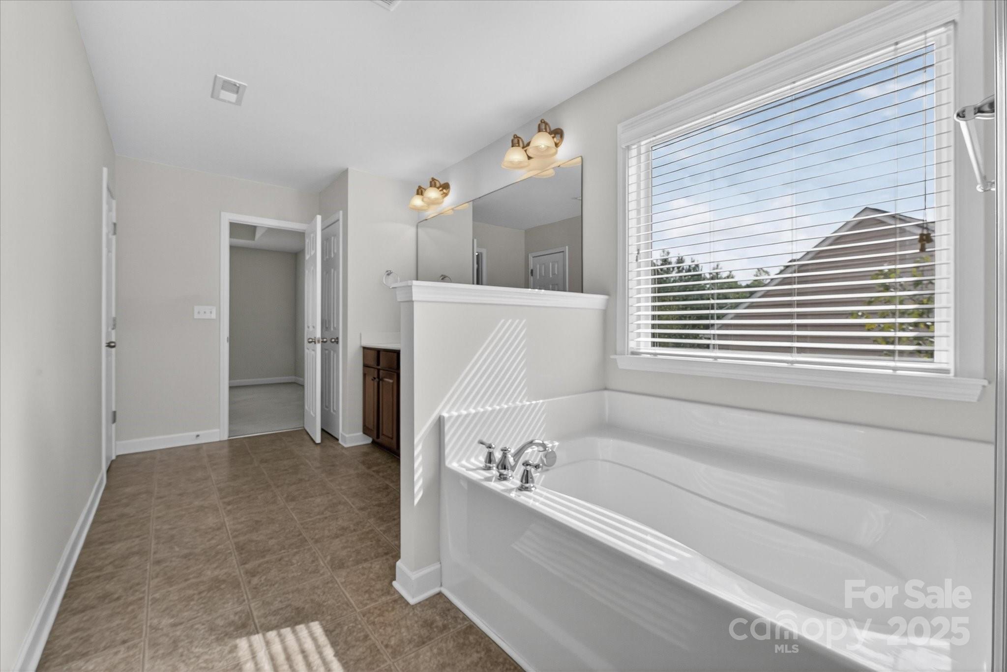 945 Vogel Way Fort Mill, SC 29715 - Photo 29 of 47 a bathroom with a bathtub and a shower