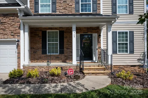 front view of a brick house with a small yard