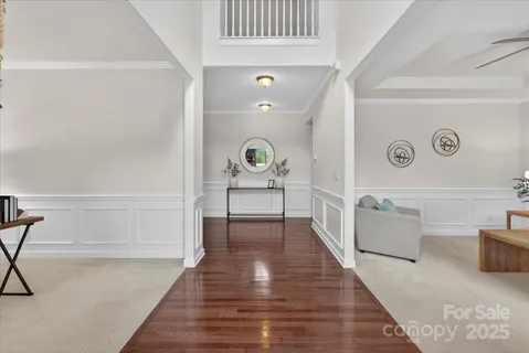 a hallway with a couch and a stove with wooden floor