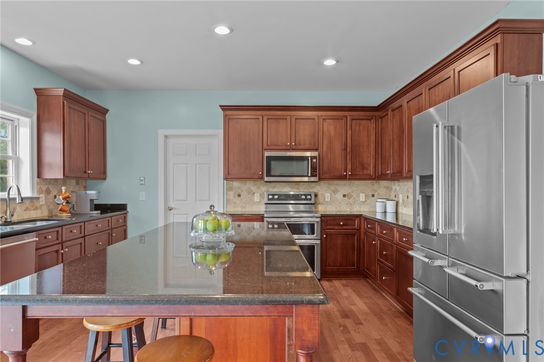 16431 River Road Chesterfield, VA 23838 - Photo 14 of 49 a kitchen with stainless steel appliances granite countertop a refrigerator a stove top oven a sink and dishwasher
