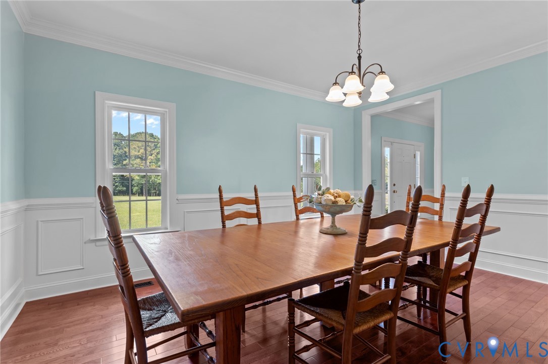 16431 River Road Chesterfield, VA 23838 - Photo 18 of 49 a view of a dining room with furniture a chandelier and wooden floor