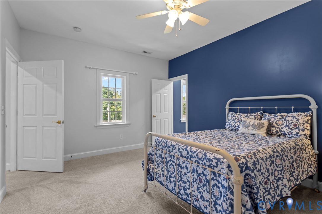 16431 River Road Chesterfield, VA 23838 - Photo 31 of 49 a bedroom with a bed and a chandelier