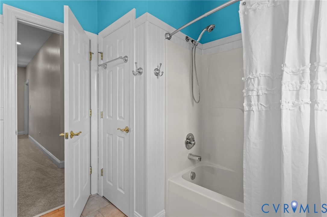 16431 River Road Chesterfield, VA 23838 - Photo 33 of 49 a bathroom with a bathtub and a shower