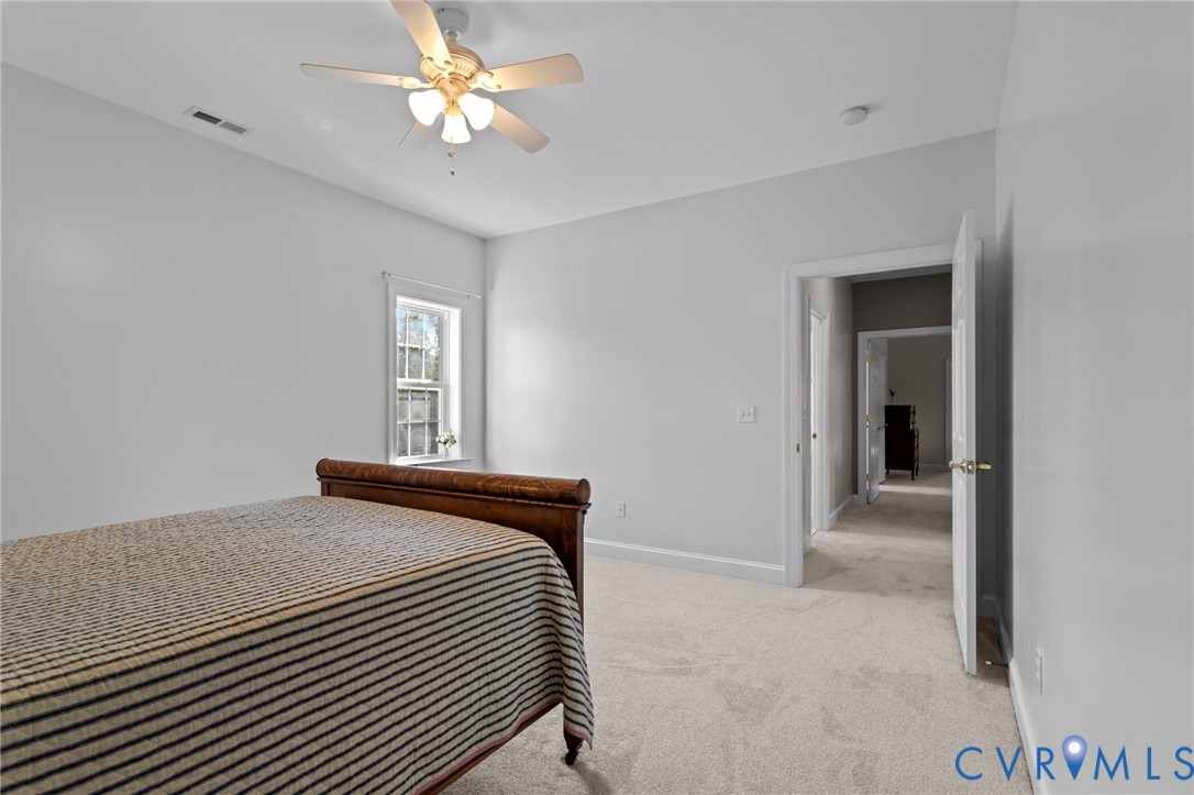 16431 River Road Chesterfield, VA 23838 - Photo 35 of 49 a bedroom with a bed and a ceiling fan