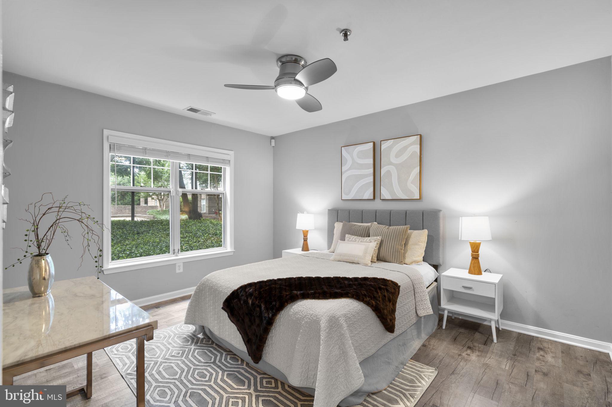 5575 Seminary Road, Unit 102 Falls Church, VA 22041 - Photo 24 of 31 a bedroom with a bed and a table with windows