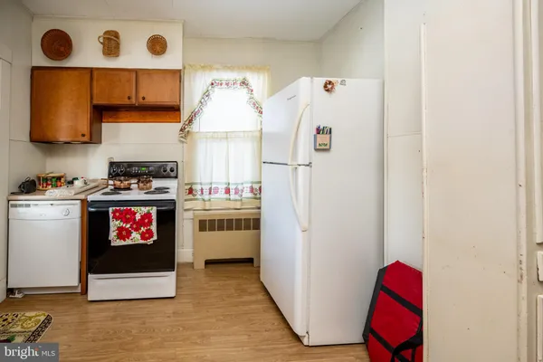 a kitchen with a stove a sink and a refrigerator
