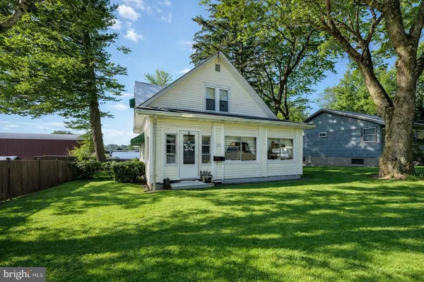 a view of a house with a wooden fence