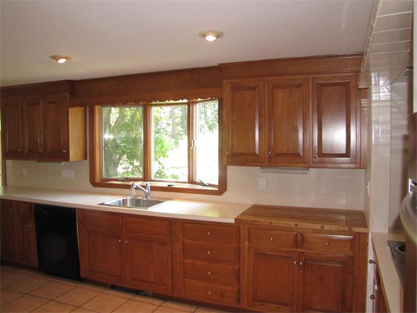 66 Harvard Road Stow, MA 01775 - Photo 11 of 30 a kitchen with a sink window and cabinets
