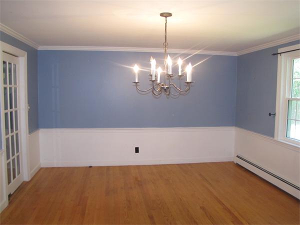 66 Harvard Road Stow, MA 01775 - Photo 13 of 30 a view of a room with a chandelier fan and wooden floor