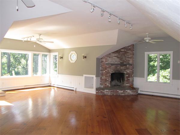 66 Harvard Road Stow, MA 01775 - Photo 14 of 30 a view of a livingroom with a fireplace and window