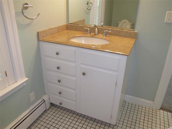 66 Harvard Road Stow, MA 01775 - Photo 22 of 30 a bathroom with a sink a vanity and a mirror
