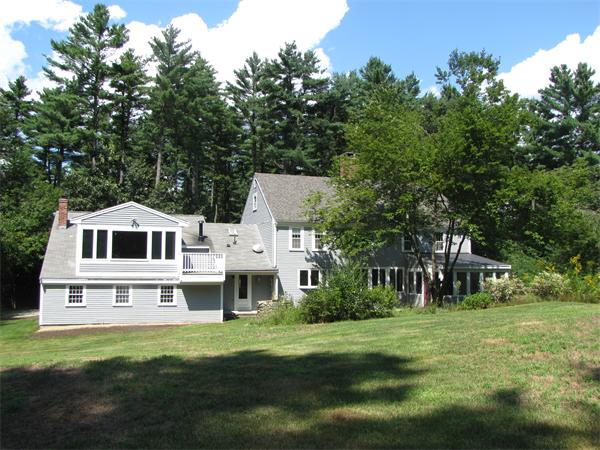 66 Harvard Road Stow, MA 01775 - Photo 25 of 30 a front view of a house with a garden
