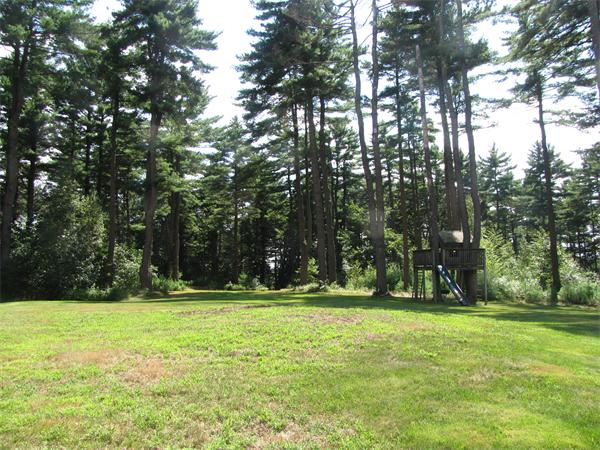 66 Harvard Road Stow, MA 01775 - Photo 26 of 30 a backyard of a house with lots of green space