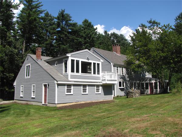 66 Harvard Road Stow, MA 01775 - Photo 3 of 30 a front view of a house with a garden