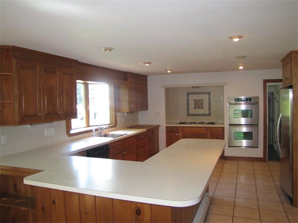 66 Harvard Road Stow, MA 01775 - Photo 10 of 30 a large kitchen with stainless steel appliances a large counter top a stove and a refrigerator