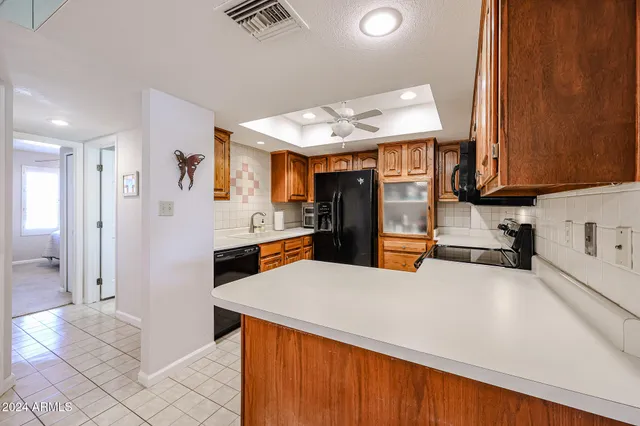 a view of a dining room with furniture and a chandelier
