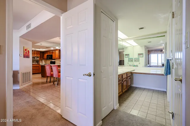 a spacious bedroom with a bed and a chandelier