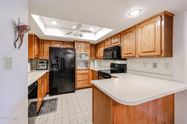 a kitchen with a refrigerator a stove top oven a sink and dishwasher