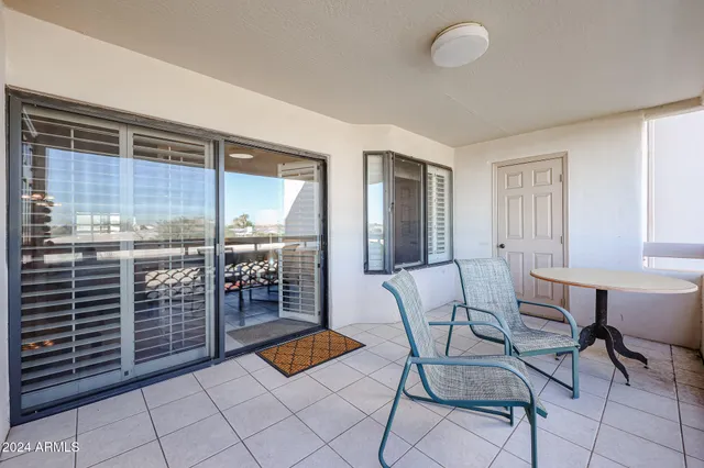 a outdoor space with a large window and furniture