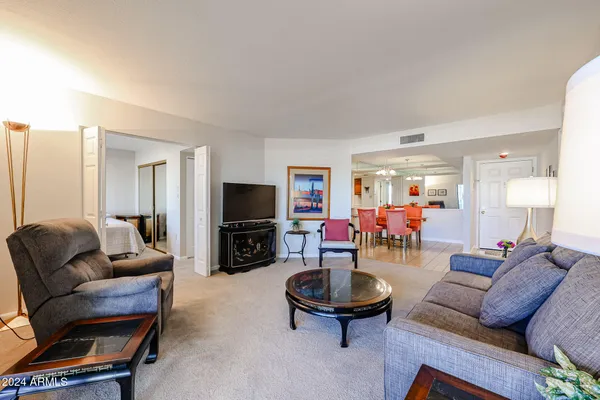 a living room with furniture and a flat screen tv