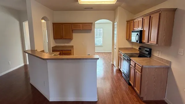 a kitchen with wooden floors and a sink