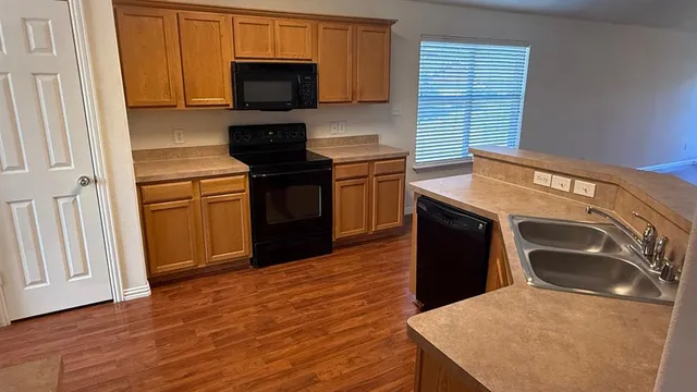 a kitchen with a stove top oven and sink