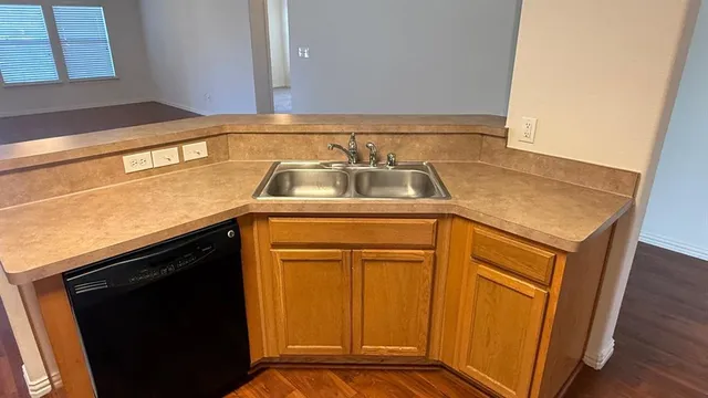 a view of an house with backyard space and balcony
