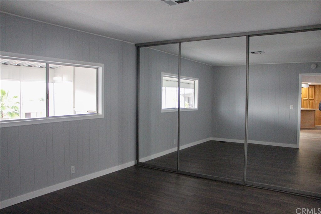 3500 Buchanan Street, Unit 6 Riverside, CA 92503 - Photo 18 of 28 a view of an empty room with wooden floor and a window