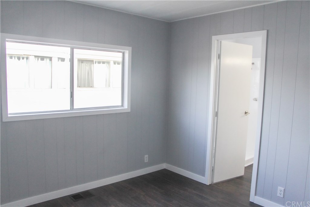 3500 Buchanan Street, Unit 6 Riverside, CA 92503 - Photo 26 of 28 an empty room with wooden floor and windows