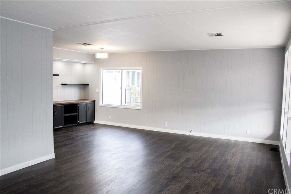 3500 Buchanan Street, Unit 6 Riverside, CA 92503 - Photo 10 of 28 an empty room with wooden floor fireplace and windows