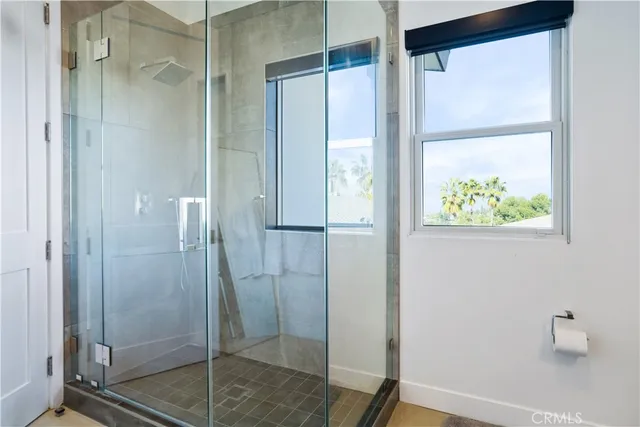 a bedroom with a large bed and a balcony