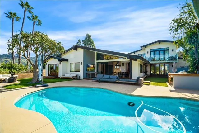 an aerial view of a house with swimming pool garden and patio
