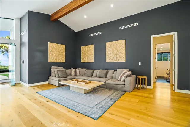 a living room with furniture and kitchen view