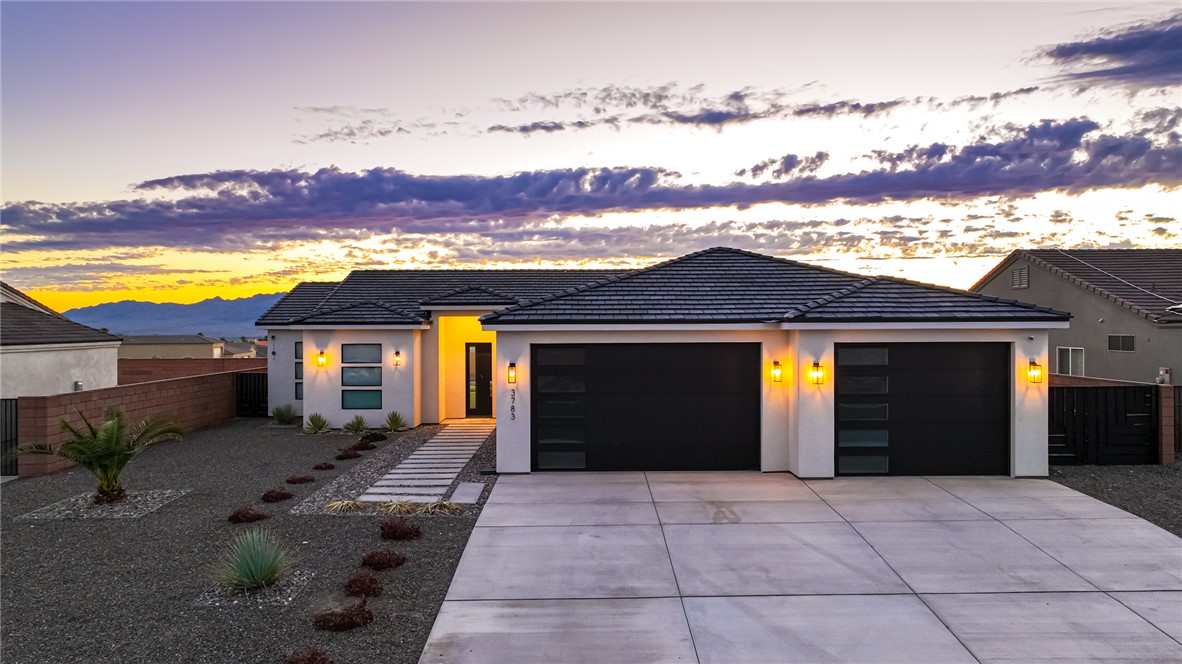 3783 Ramsey Road Bullhead City, AZ 86442 - Photo 1 of 56 a view of house with backyard and a garden