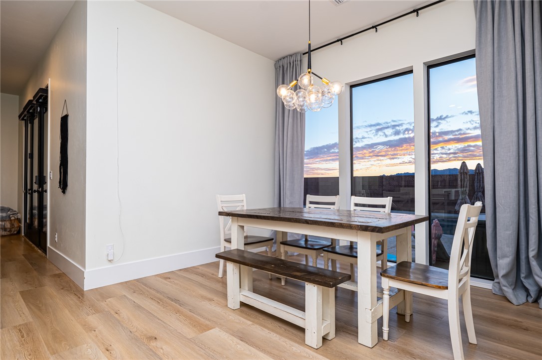 3783 Ramsey Road Bullhead City, AZ 86442 - Photo 13 of 56 a view of a dining room with furniture window and wooden floor