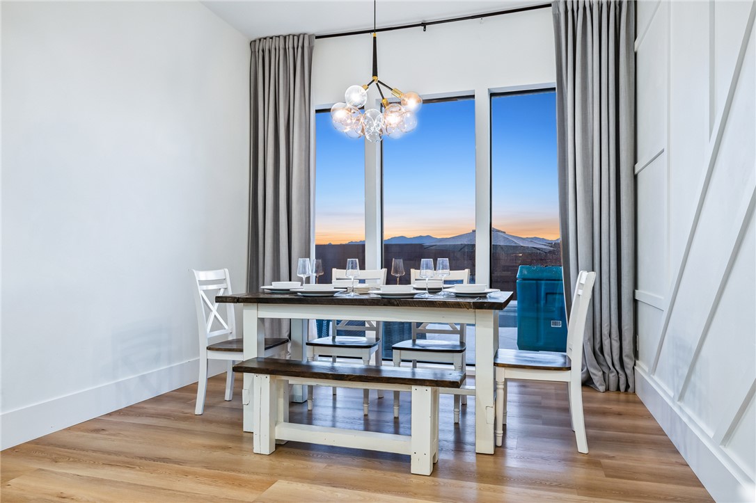 3783 Ramsey Road Bullhead City, AZ 86442 - Photo 15 of 56 a view of a dining room with furniture wooden floor and chandelier