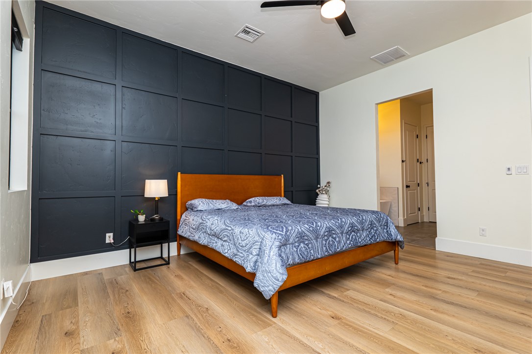 3783 Ramsey Road Bullhead City, AZ 86442 - Photo 19 of 56 a bedroom with a bed and a chandelier