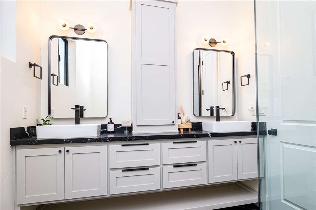 3783 Ramsey Road Bullhead City, AZ 86442 - Photo 36 of 56 a bathroom with a double vanity sink and mirror