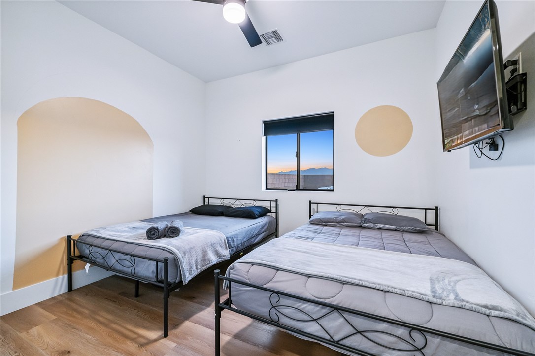 3783 Ramsey Road Bullhead City, AZ 86442 - Photo 38 of 56 a bedroom with 2 bed and a chandelier