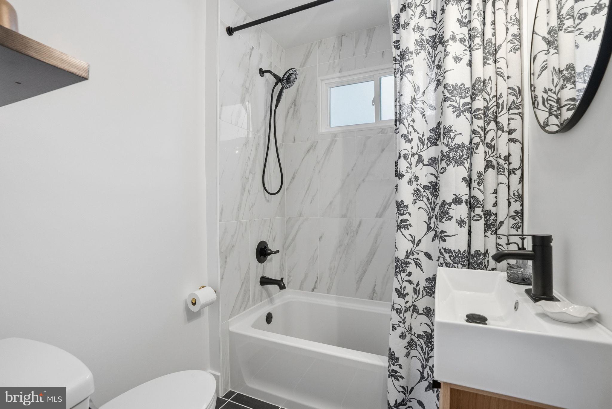 303 Radcliffe Road Glenside, PA 19038 - Photo 17 of 36 a bathroom with a toilet and a shower curtain