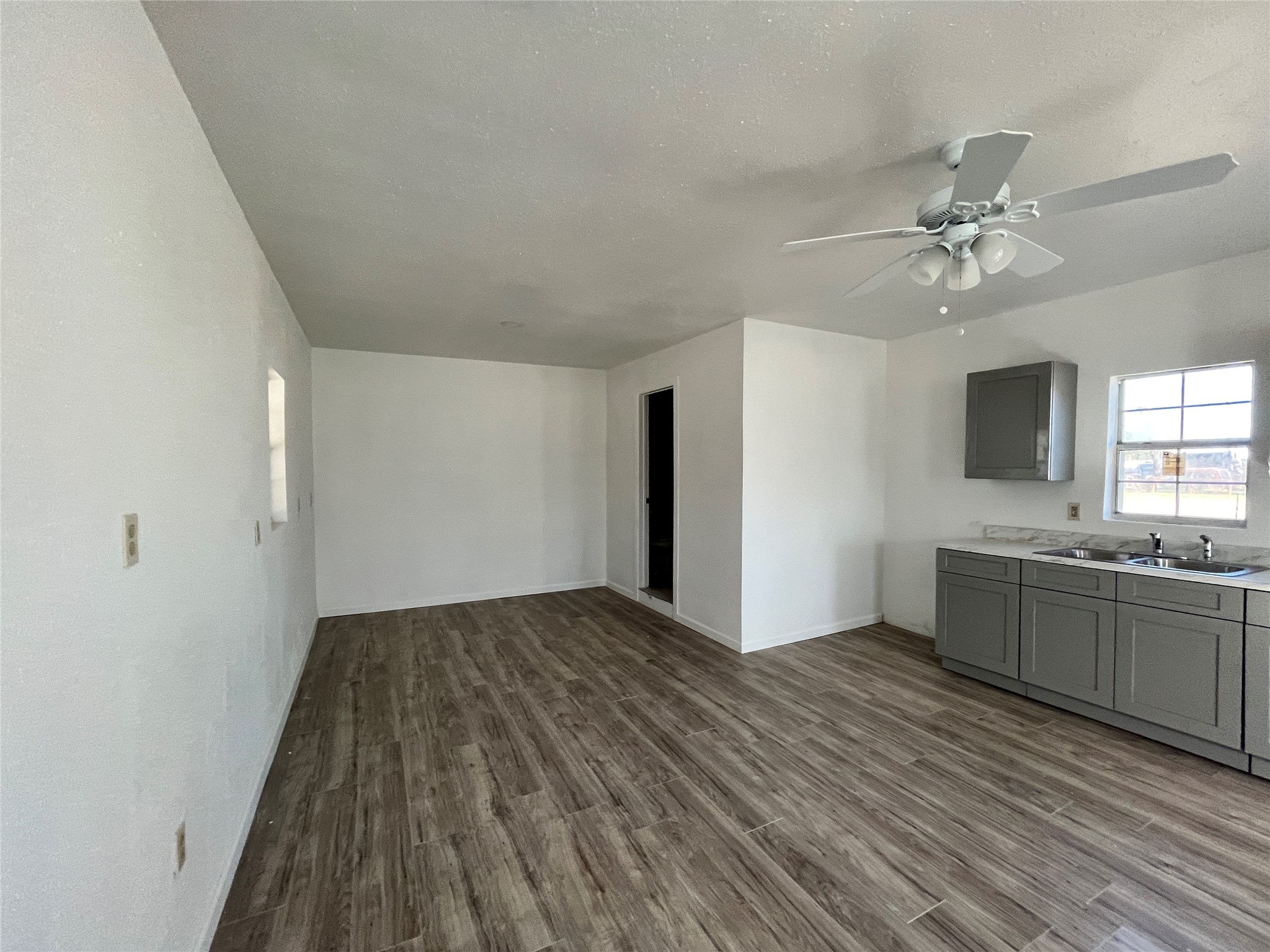 5104 39th Street East, Unit 4 Dickinson, TX 77539 - Photo 5 of 7 wooden floor in an empty room with a kitchen