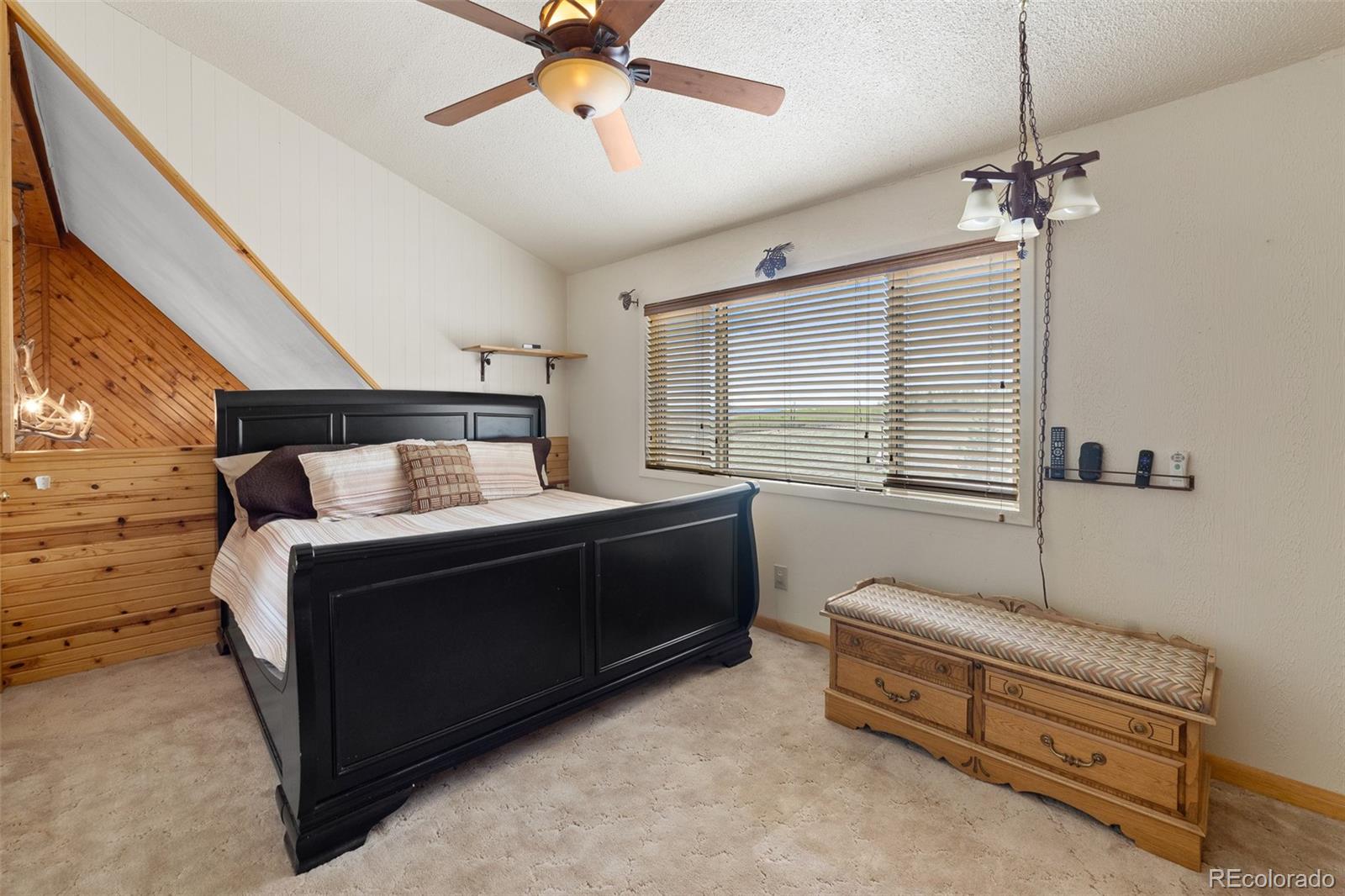1163 Michigan Hill Road Jefferson, CO 80456 - Photo 32 of 48 a bed room with a bed and a window