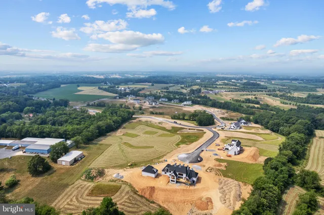 an aerial view of a residential houses with outdoor space