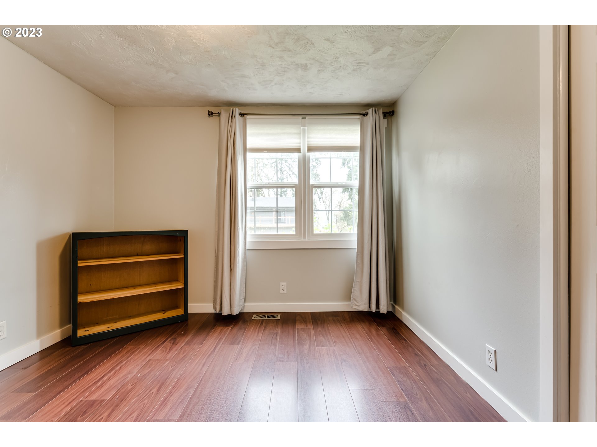 6973 Glacier Drive Springfield, OR 97478 - Photo 19 of 34 a view of wooden floor and windows in a room