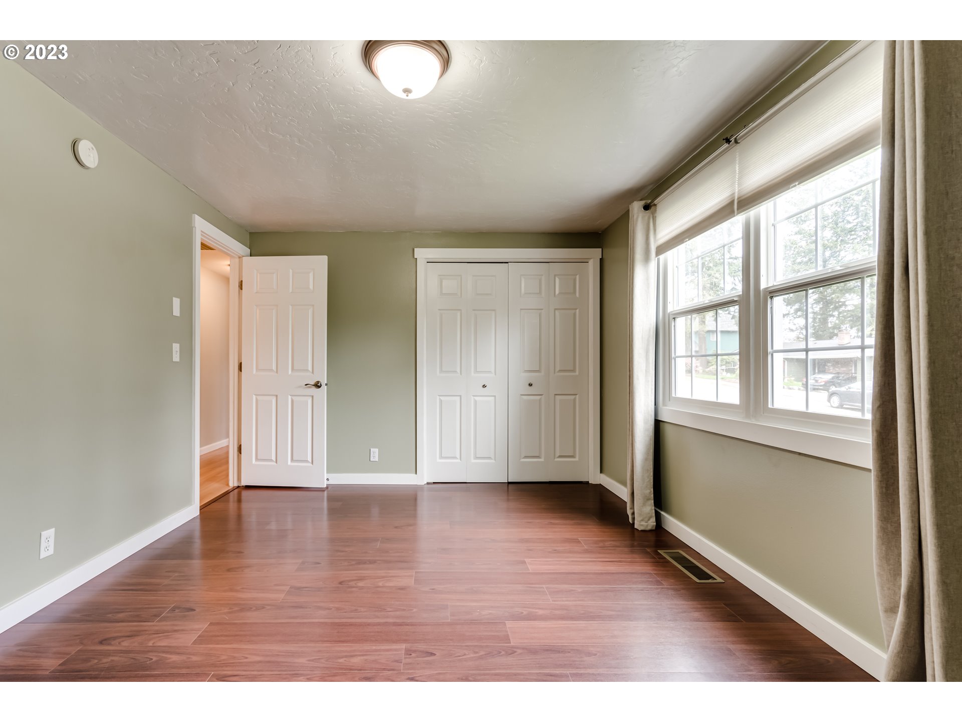 6973 Glacier Drive Springfield, OR 97478 - Photo 20 of 34 a view of an empty room with wooden floor and a window